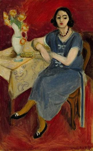 蓝色女人在桌子上，红色背景 Woman in Blue at a Table, Red Background (1923)，亨利·马蒂斯